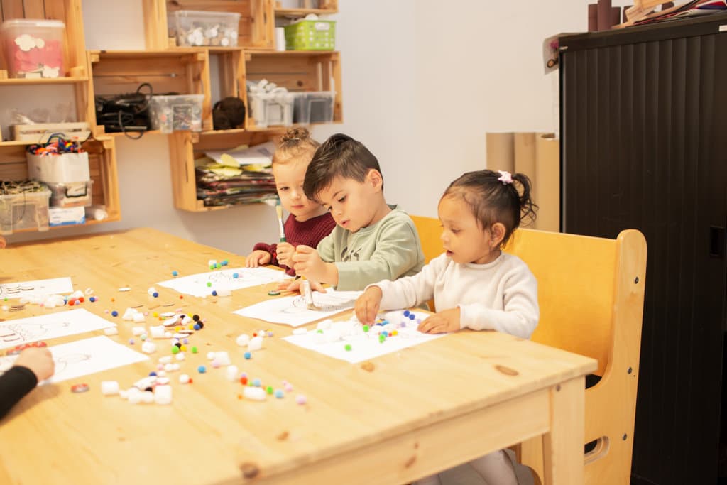 Kinderen knutselen samen aan tafel bij De Groene Tuin